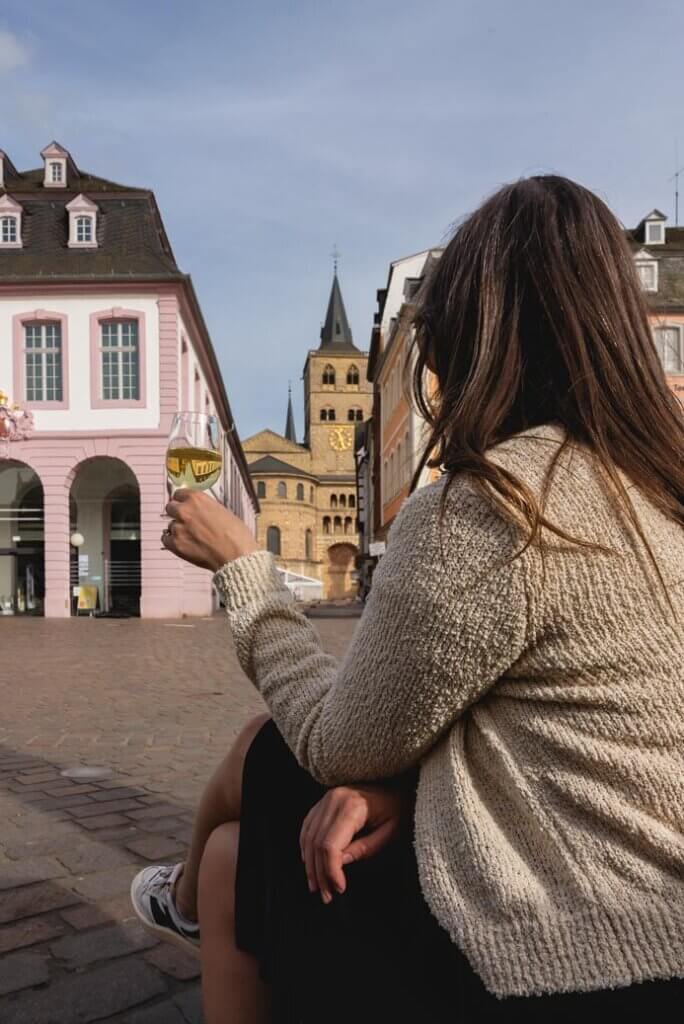 Megan enjoying a glass of wine in Hauptmarkt from the Wine Stand in Trier Germany