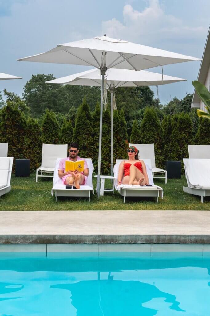Scott and Megan lounging poolside at the Lakeside Motel in Prince Edward County Ontario