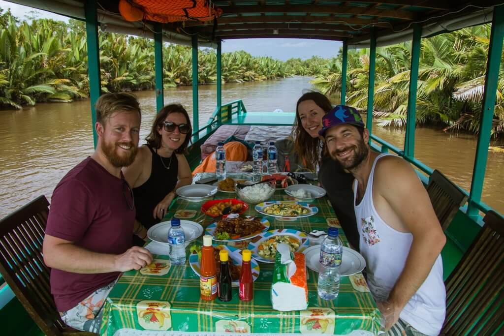 The four of us enjoying lunch on the klotok during our river cruise through the jungle of Borneo Indoneisa