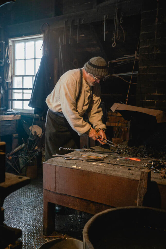 Carmen Legge from The Curse of Oak Island in blacksmith shop at Ross Farm Museum in Nova Scotia