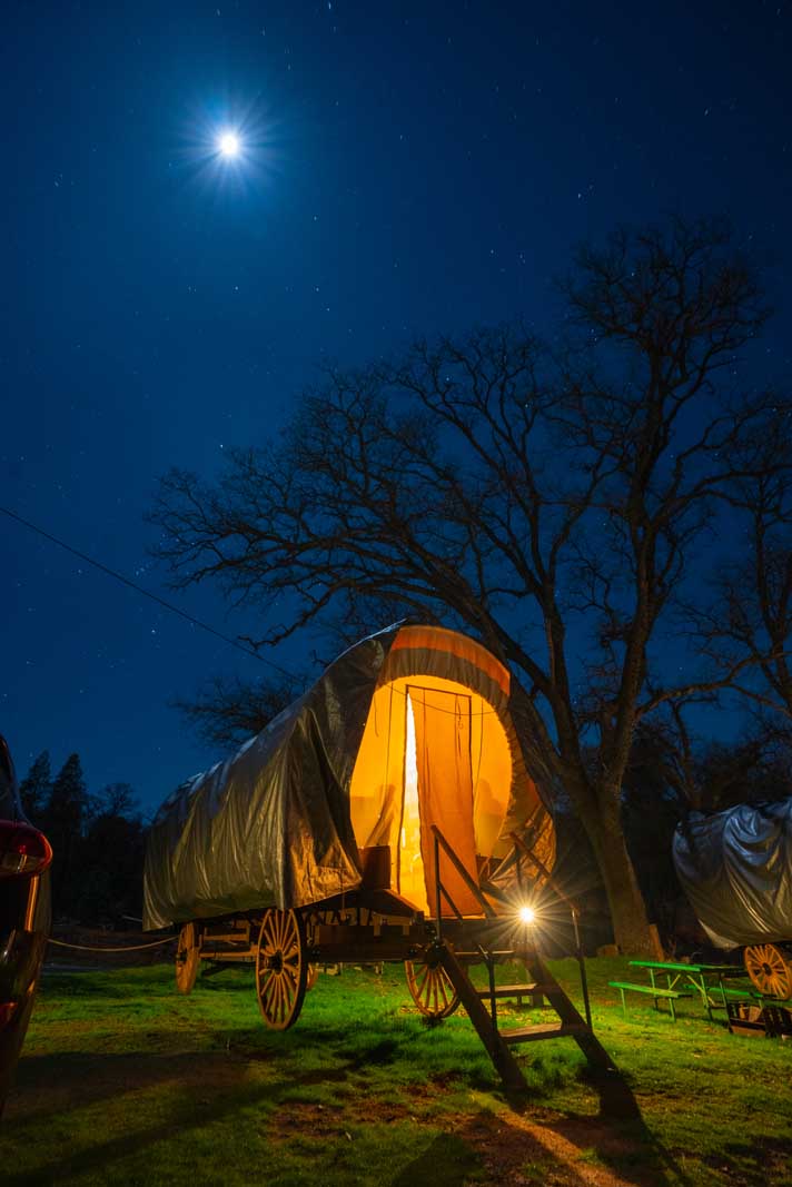 Our Covered Wagon at night at Yosemite Pines RV Resort