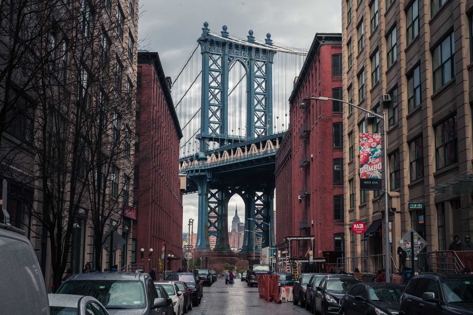 View of Manhatten Bridge with Empire State Building in DUMBO Brooklyn