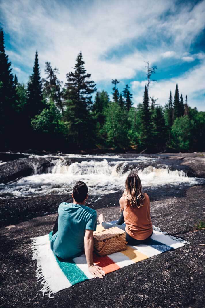 Having a picnic at Pine Point Rapids on a hudson bay company blanket