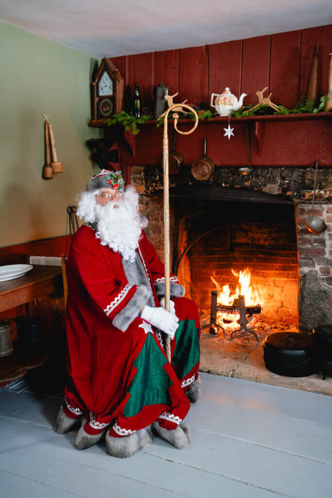Father Christmas by the fireside at the New Ross Museum in Nova Scotia at Christmas