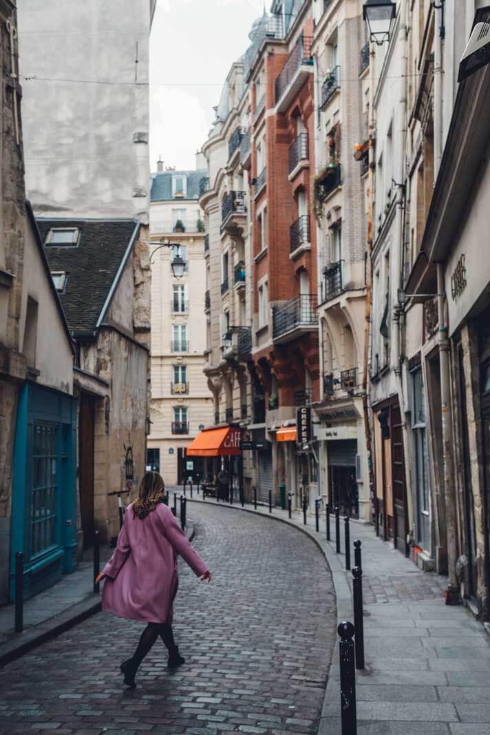 Megan walking down a gorgeous street in Paris