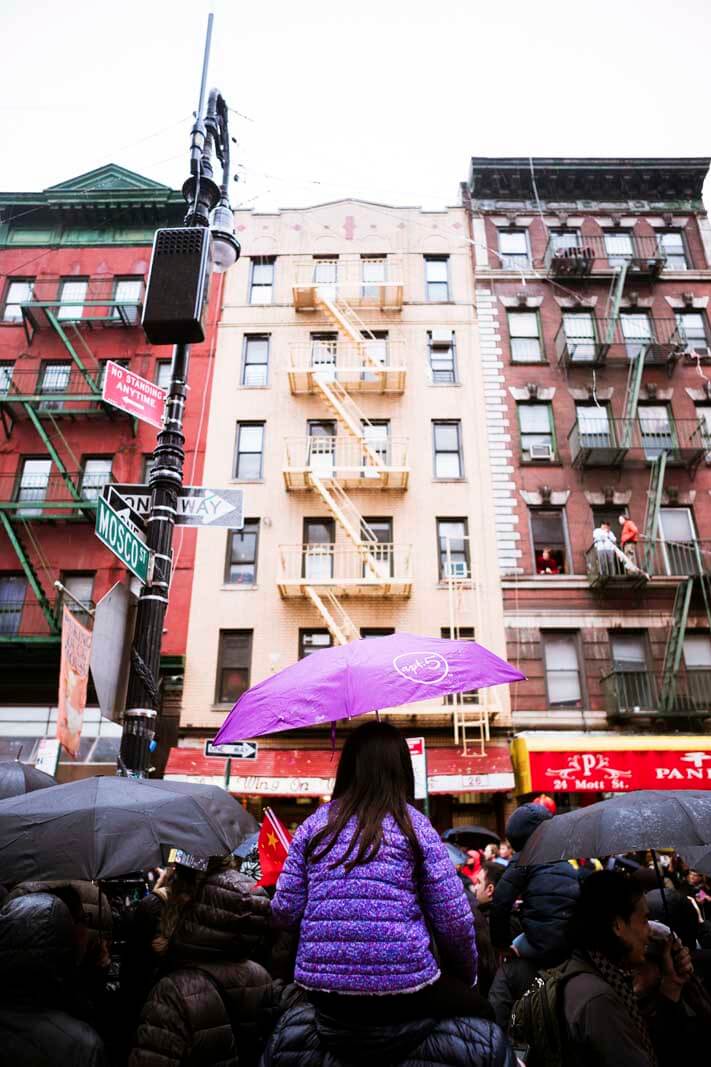 Little girl watching the Lunar New Year Parade in Chinatown in NYC