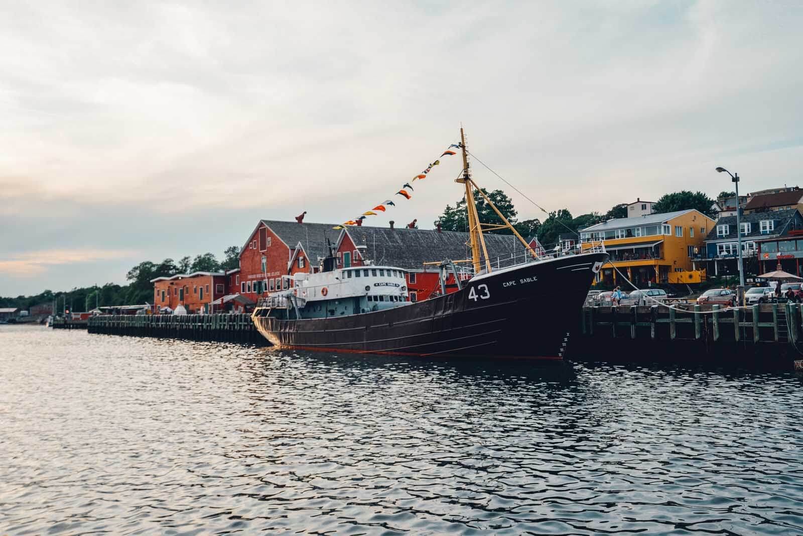 The city of Lunenburg by water with a fishing boat