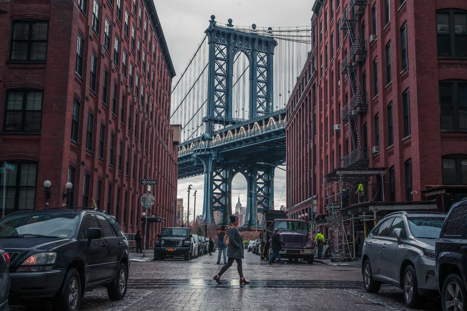 Megan walking in the iconic DUMBO spot