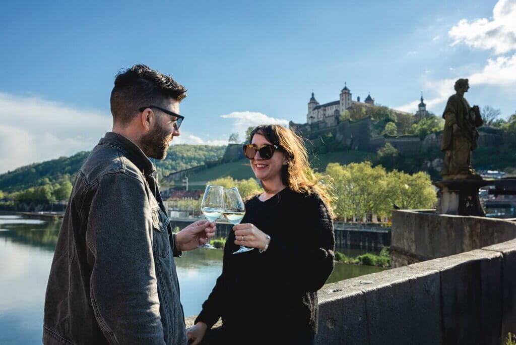Megan and Scott drinking wine on the Old Main Bridge in Wurzburg Germany