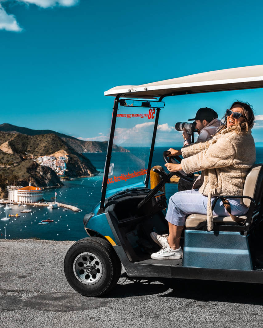 Megan and Scott enjoying a scenic golf cart ride on Catalina Island in California