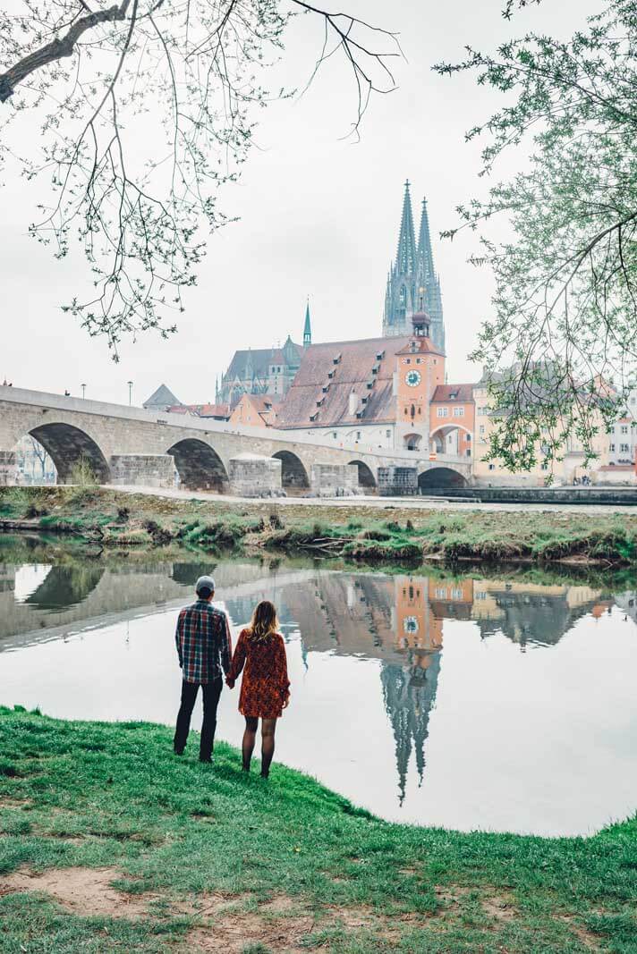 Megan and Scott enjoying a view of the stone bridge and cathedral in Regensburg Germany
