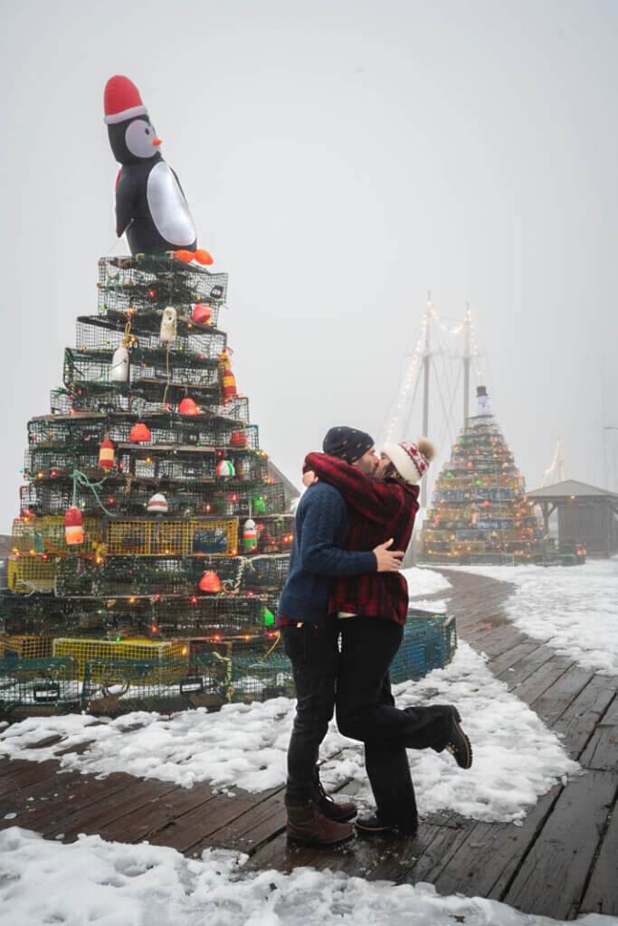 Megan and Scott in front of the Lunenburg Lobster Trap Christmas Trees in Nova Scotia