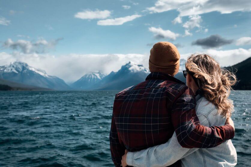 Megan and Scott looking at the mountains in Glacier National Park from Apgar