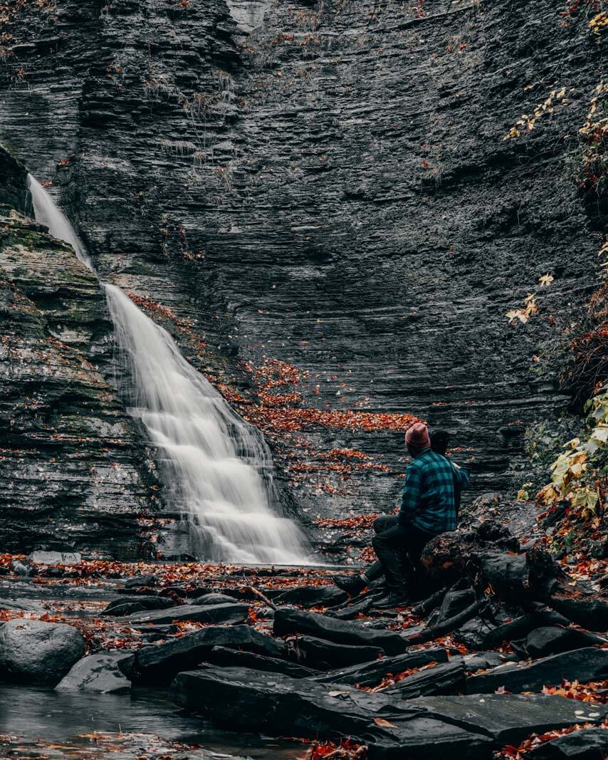 Megan and Scott sitting at admiring the second waterfall in Grimes Glen Park in Naples New York