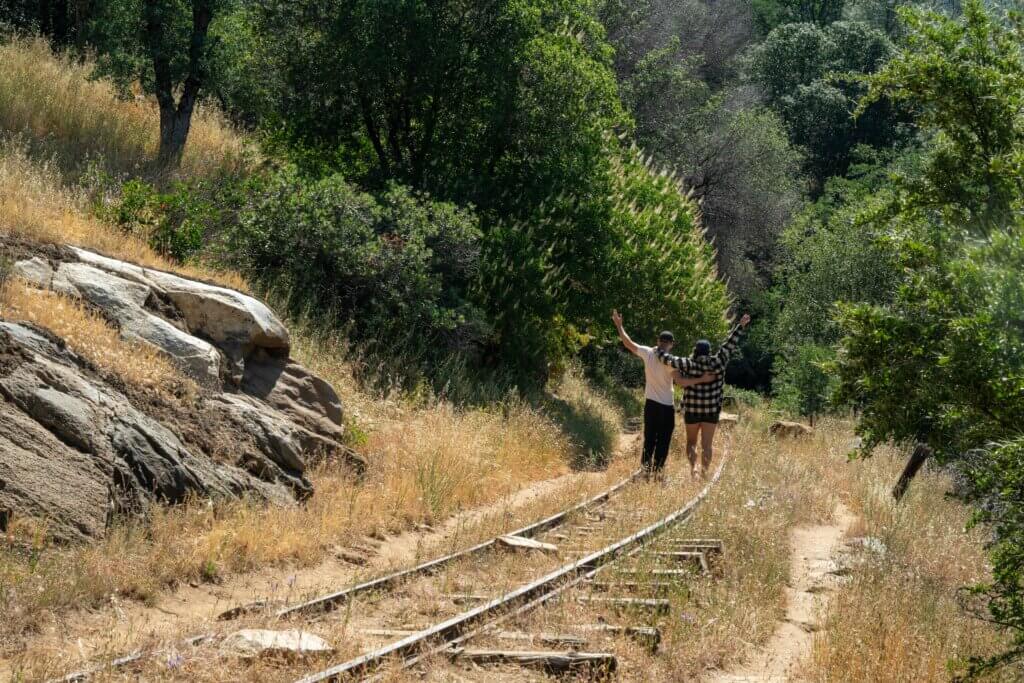 Megan and Scott walking along the West Side Trail in Tuolumne, California on an old railway track