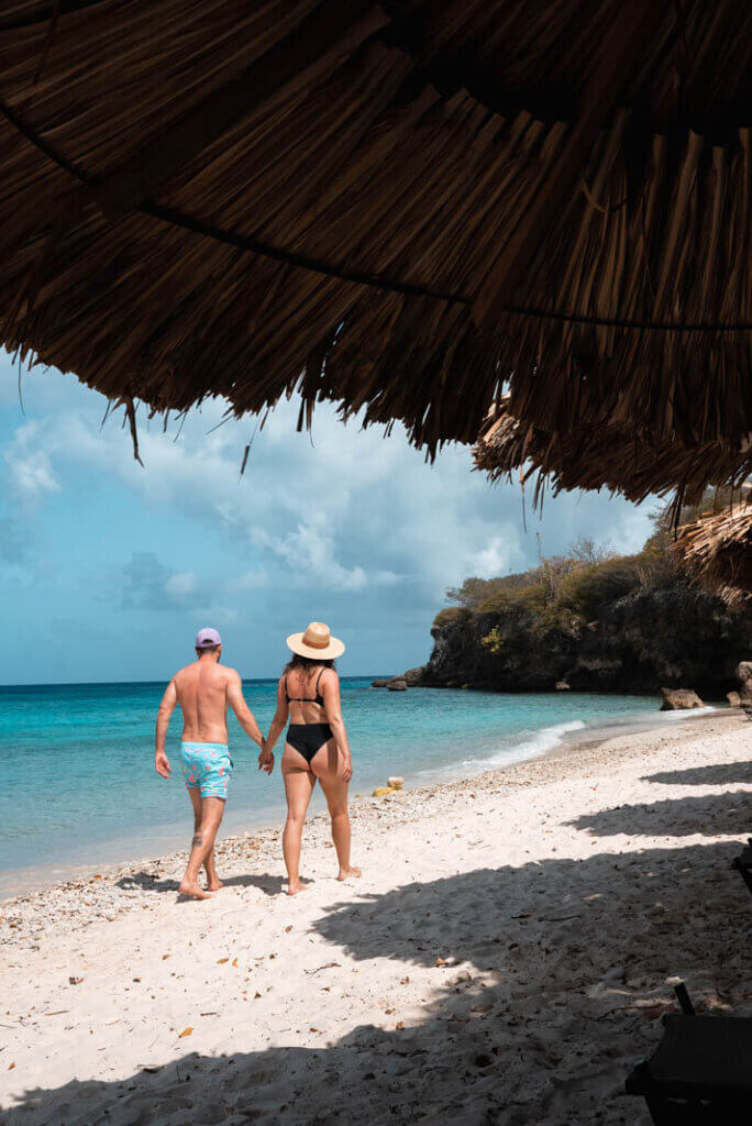 Megan and Scott walking along the beach at Playa Kalki in Westpunt Curacao holding hands