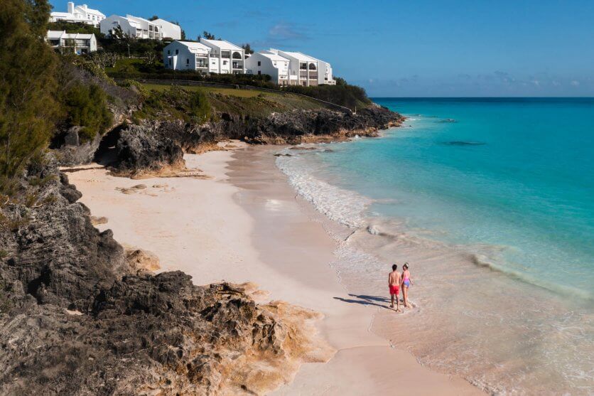 Megan and Scott walking down West Whale Bay Beach in Bermuda