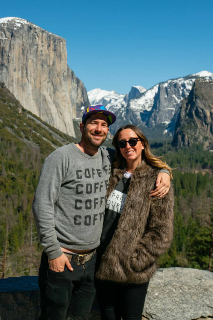 Megan-and-Scott-with-the-Yosemite-Valley-view-in-the-background-in-Yosemite-National-Park