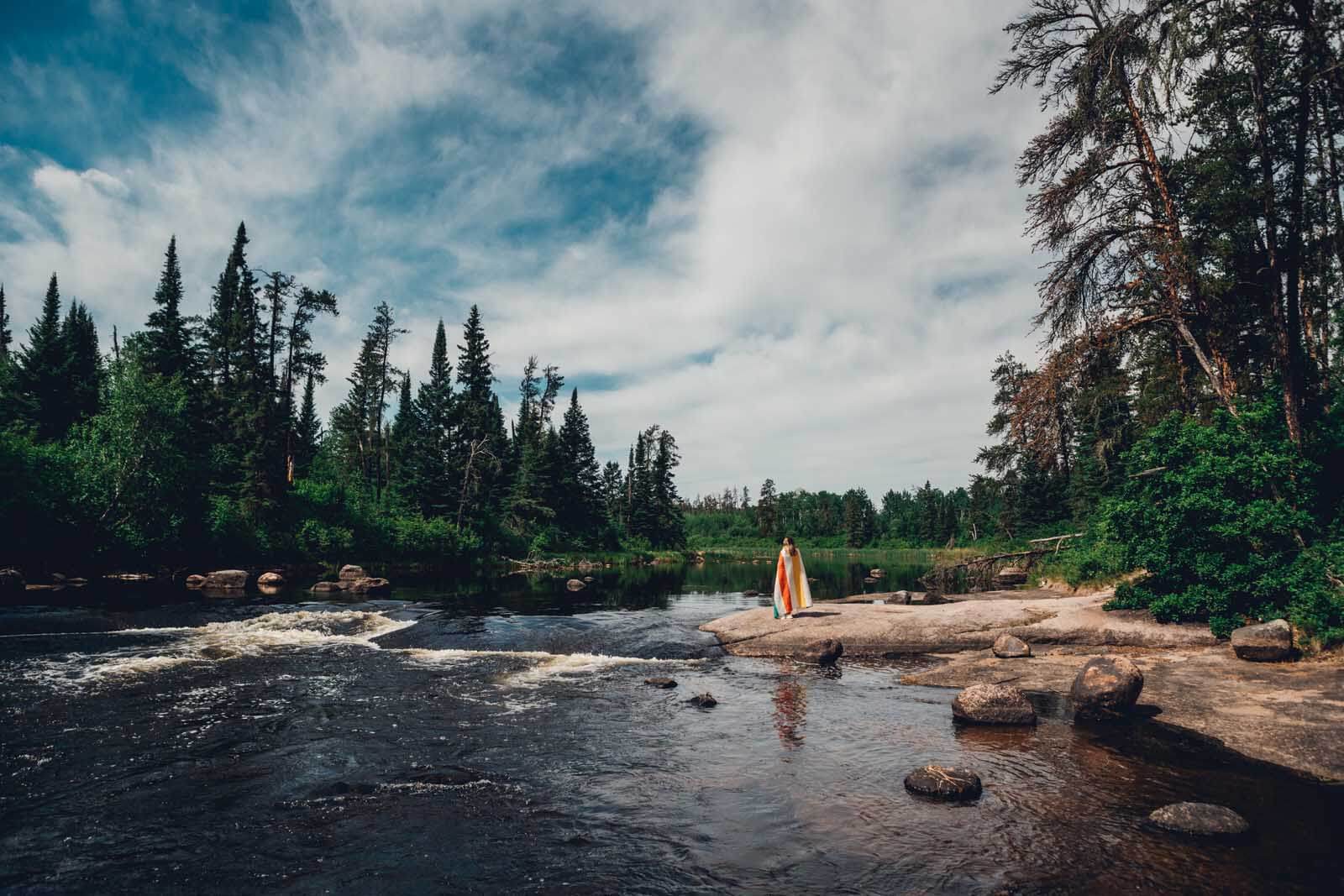 Megan standing with a view at Pine Point Rapids in Whiteshell PRovincial Park