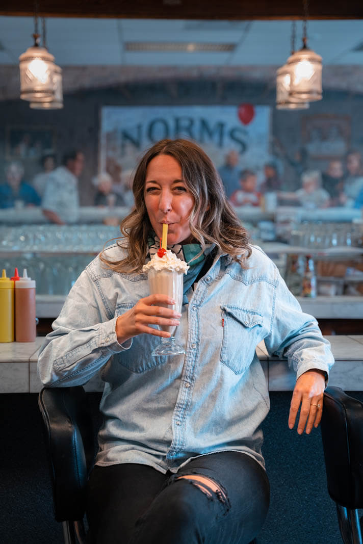 Megan enjoying a milkshake at Norms Soda Fountain in Kalispell Montana