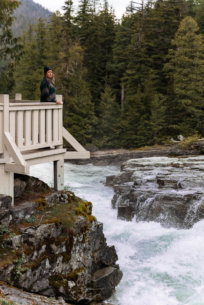 Megan enjoying the view at Lake McDonald Falls on Going to the Sun Road in Glacier National Park