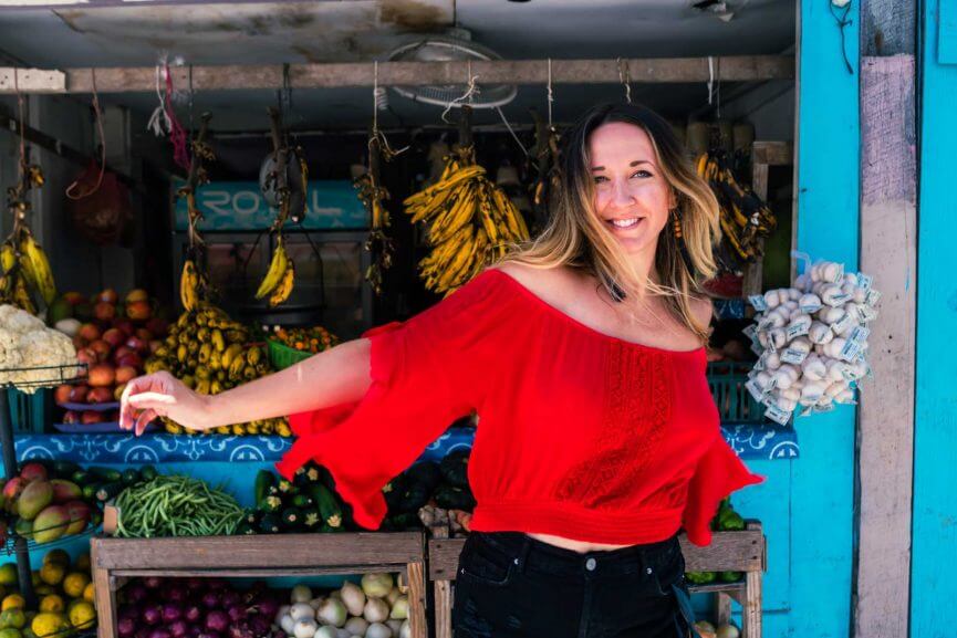 Megan in San Pedro Belize in front of the fruit stand