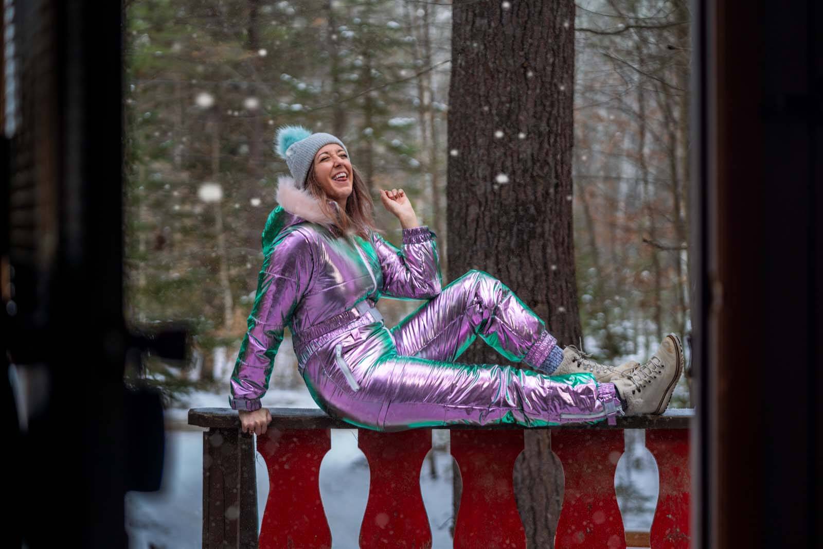 Megan in her electric snow suit with her winter boots on in the Adirondacks in winter