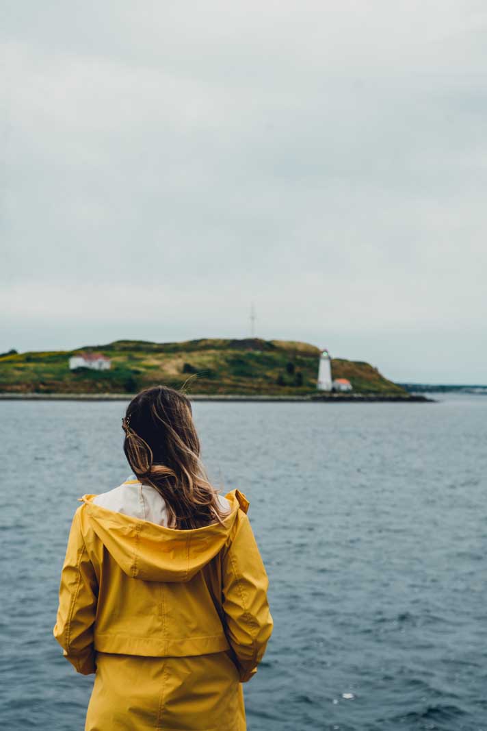 Megan looking at Georges Island lighthouse and island from the Halifax Waterfront