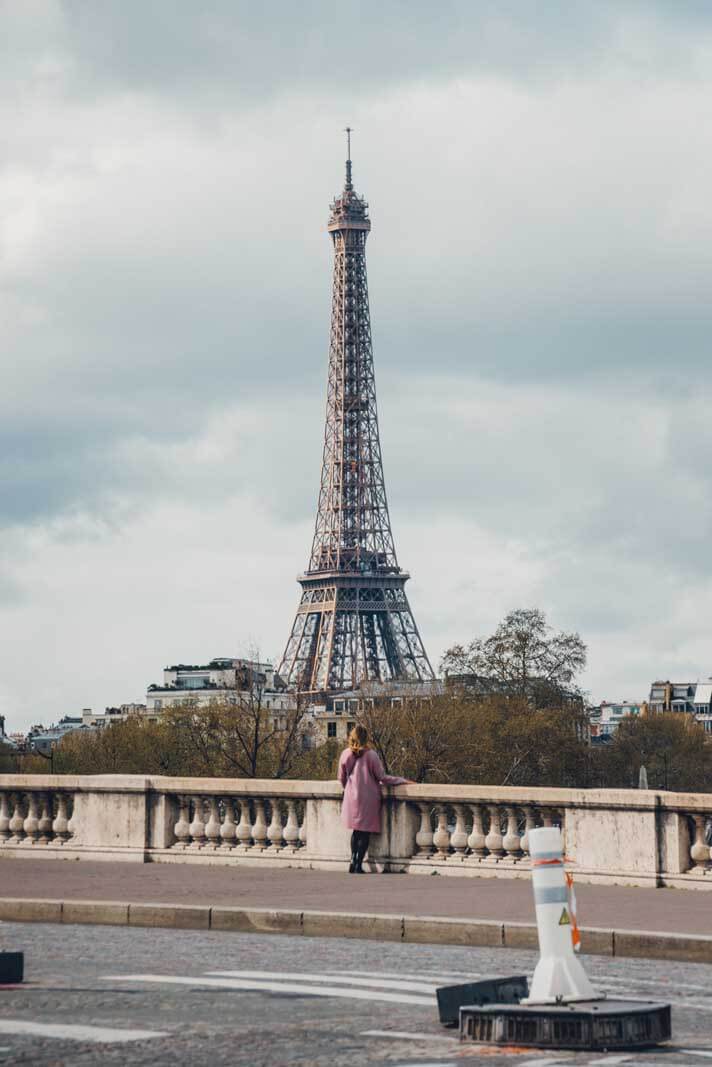 Megan looking at the Eiffel Tower from a bridge in Paris