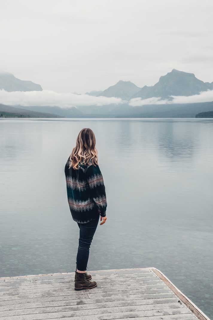 Megan looking at the mountains across from Lake McDonald in Glacier National Park in Montana