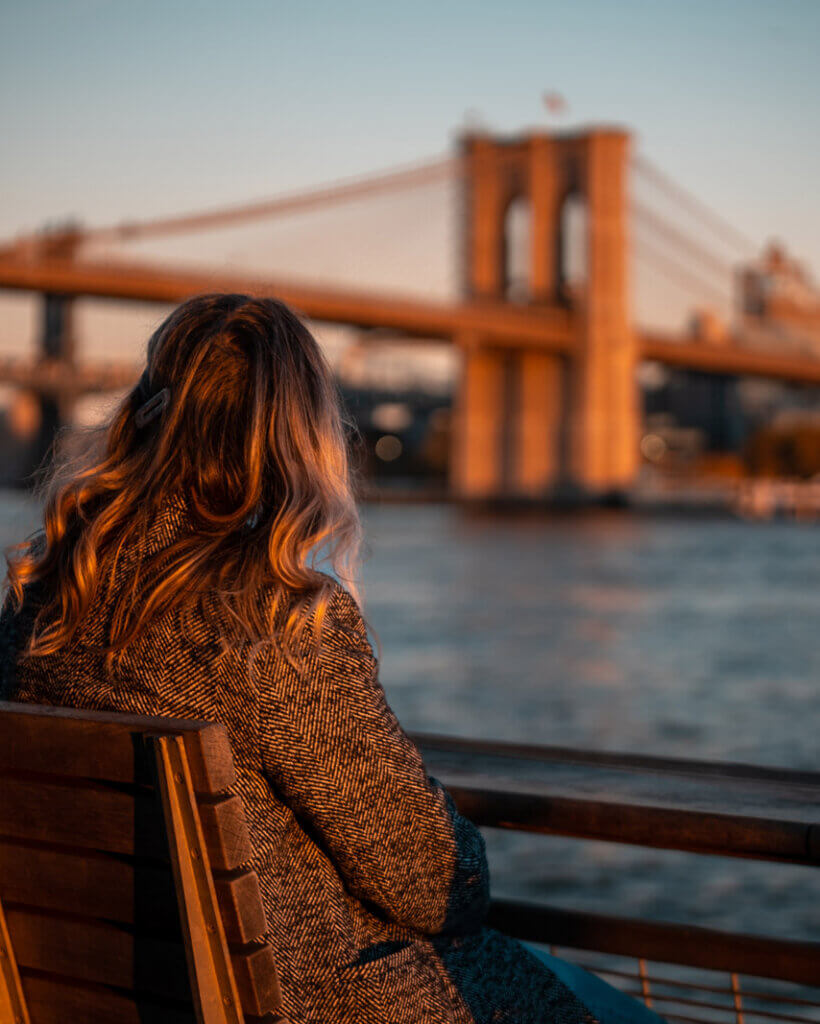Megan looking at the view of the Brooklyn Bridge from Pier 16 in South Street Seaport District in Lower Manhattan