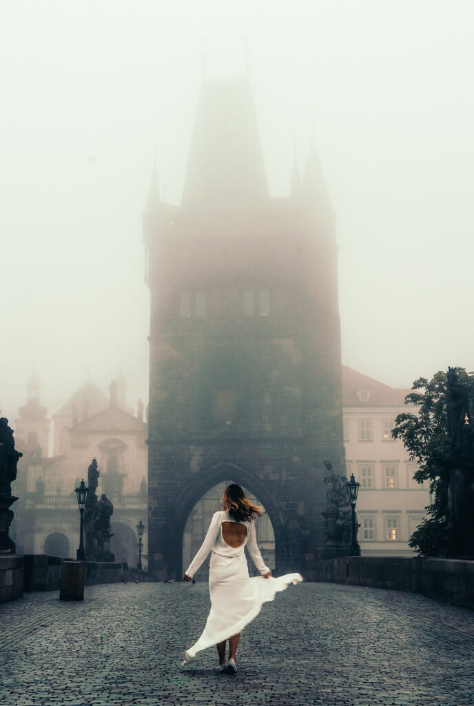 Megan on Charles Bridge in Prague at sunrise all by herself