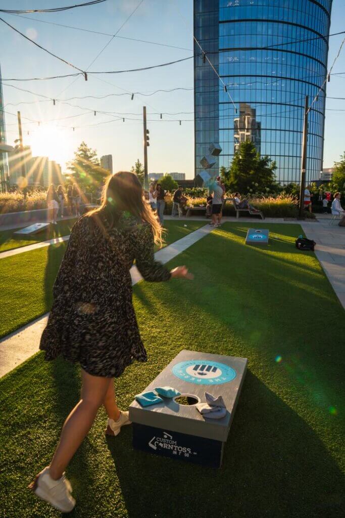 Megan playing cornhole at The Perch at the Capital One Center in Fairfax County Virginia