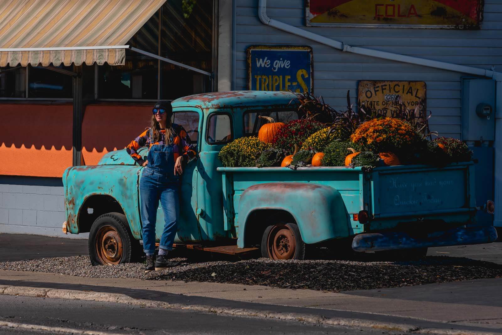 Megan posing near a fall vintage truck in Seneca Falls in Upstate New York