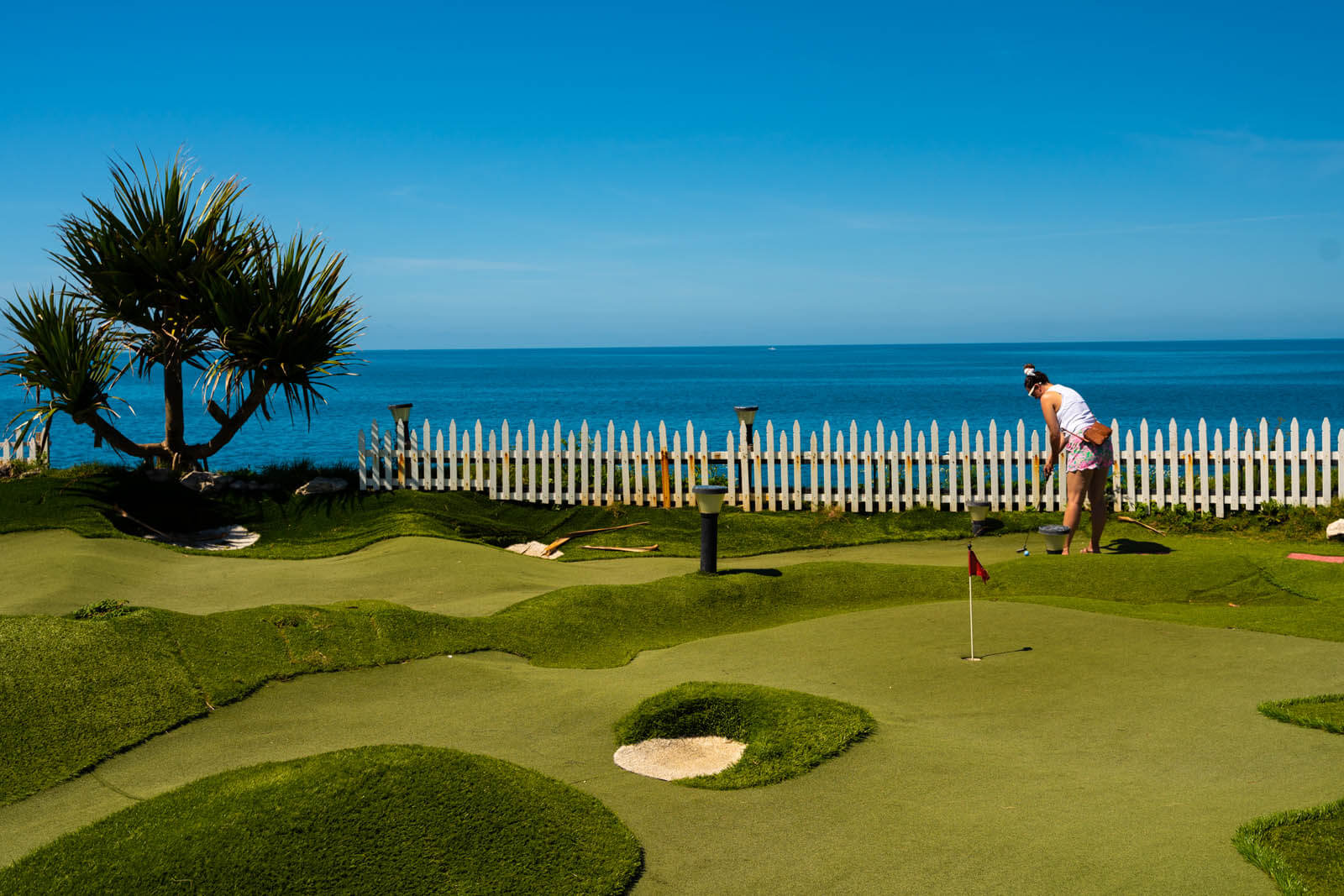 Megan putting at Bermuda Fun Golf in the Royal Dockyard