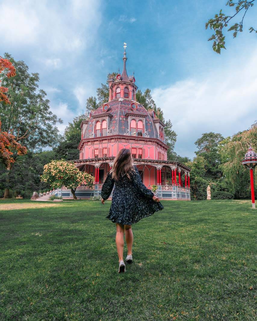 Megan running towards the whimsical Armour Stinner house in Tarrytown NY