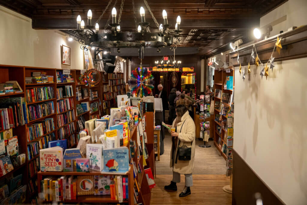 Megan shopping for books with a beer at Spotty Dog Books and Ale in Hudson NY