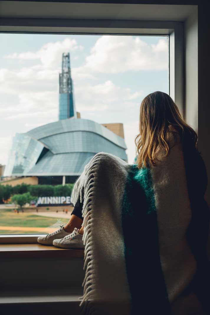 Megan looking at the view of the Cnaadian Museum of Human Rights from our room at Inn at the Forks in Winnipeg 