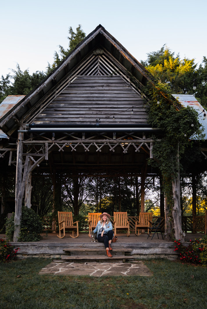 Megan sitting with a cat at Lawnchair Theatre in Leipers Fork Tennessee