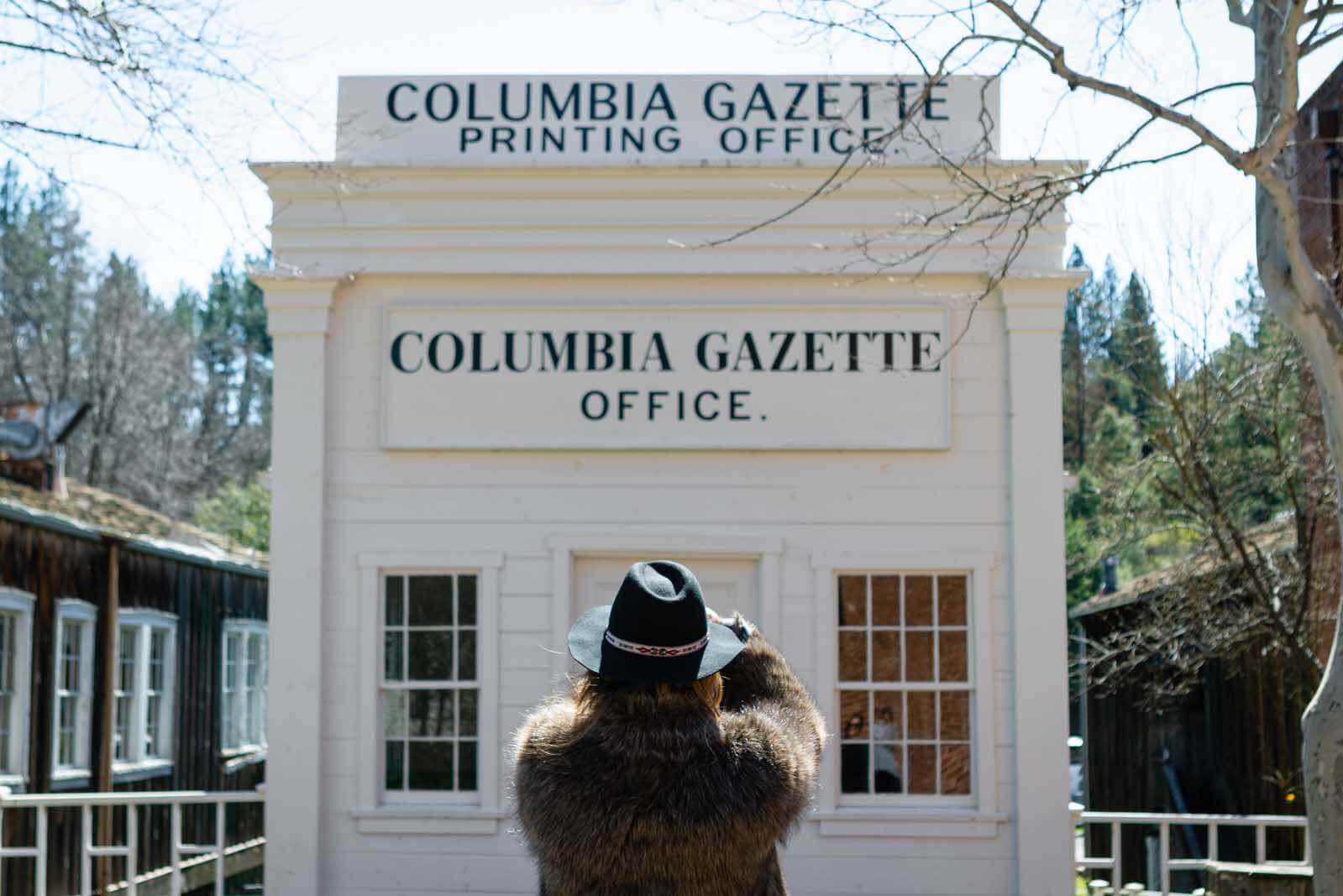 Megan taking a photo at the Columbia Gazette office at Columbia State Historic Park