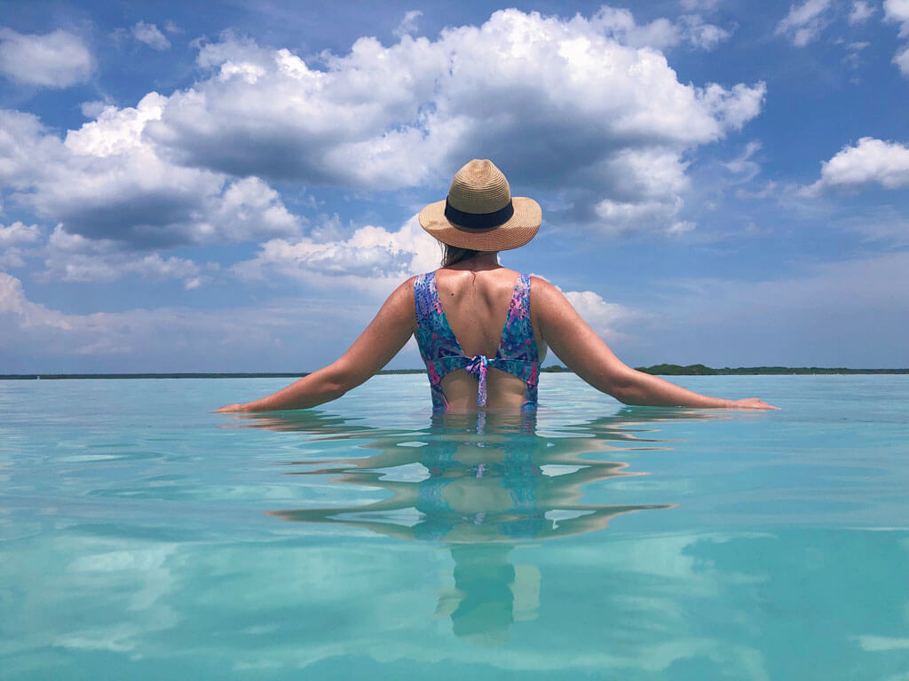 Megan touching water at Bacalar Lagoon