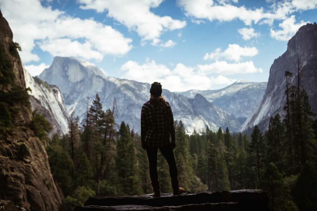 Megan standing at Yosemite National Park looking at the view in winter in Northern California