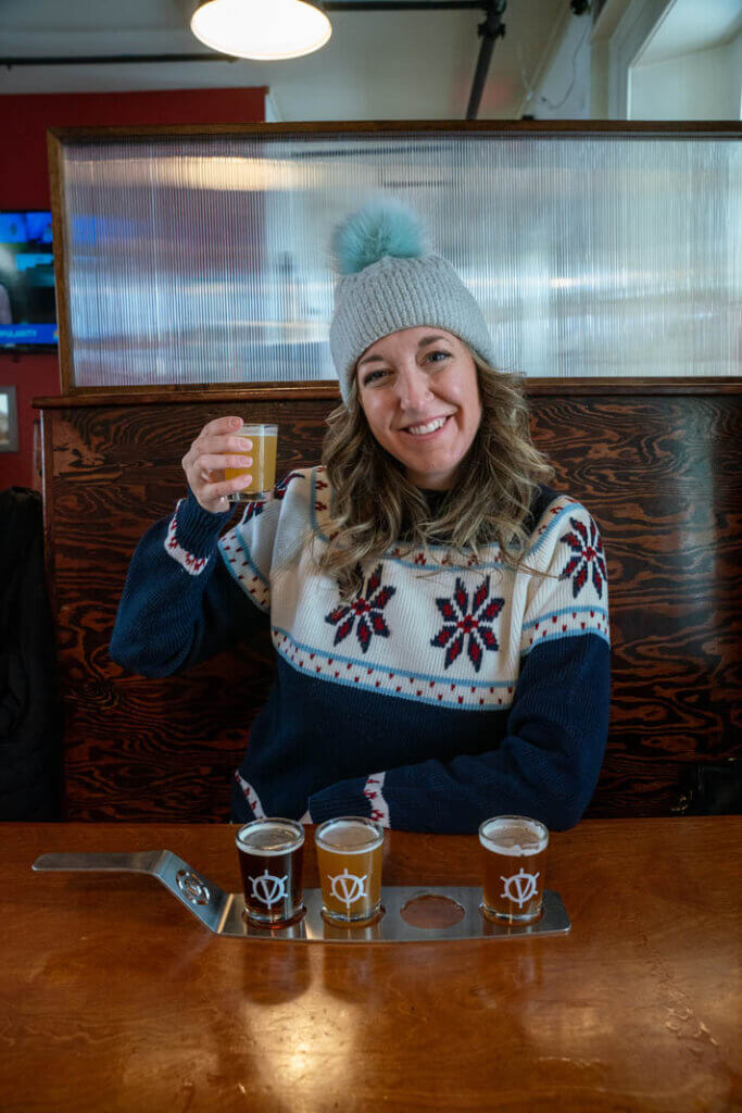 Megan trying a tasting flight of beer from Valcour Brewing in Plattsburgh New York