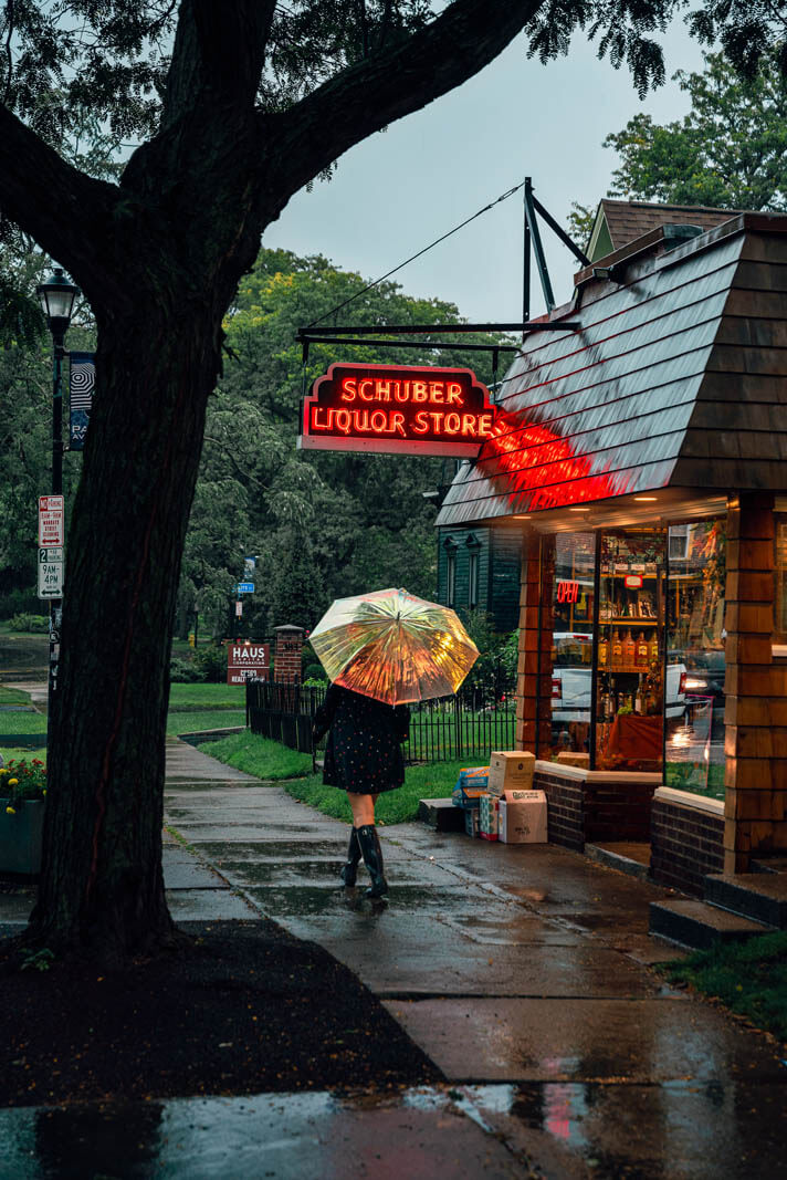 Megan walking down Park Avenue in Rochester NY in the rain