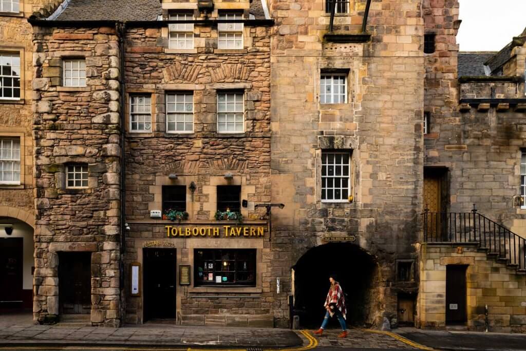 Megan walking in front of tolbooth tavern in edinburgh