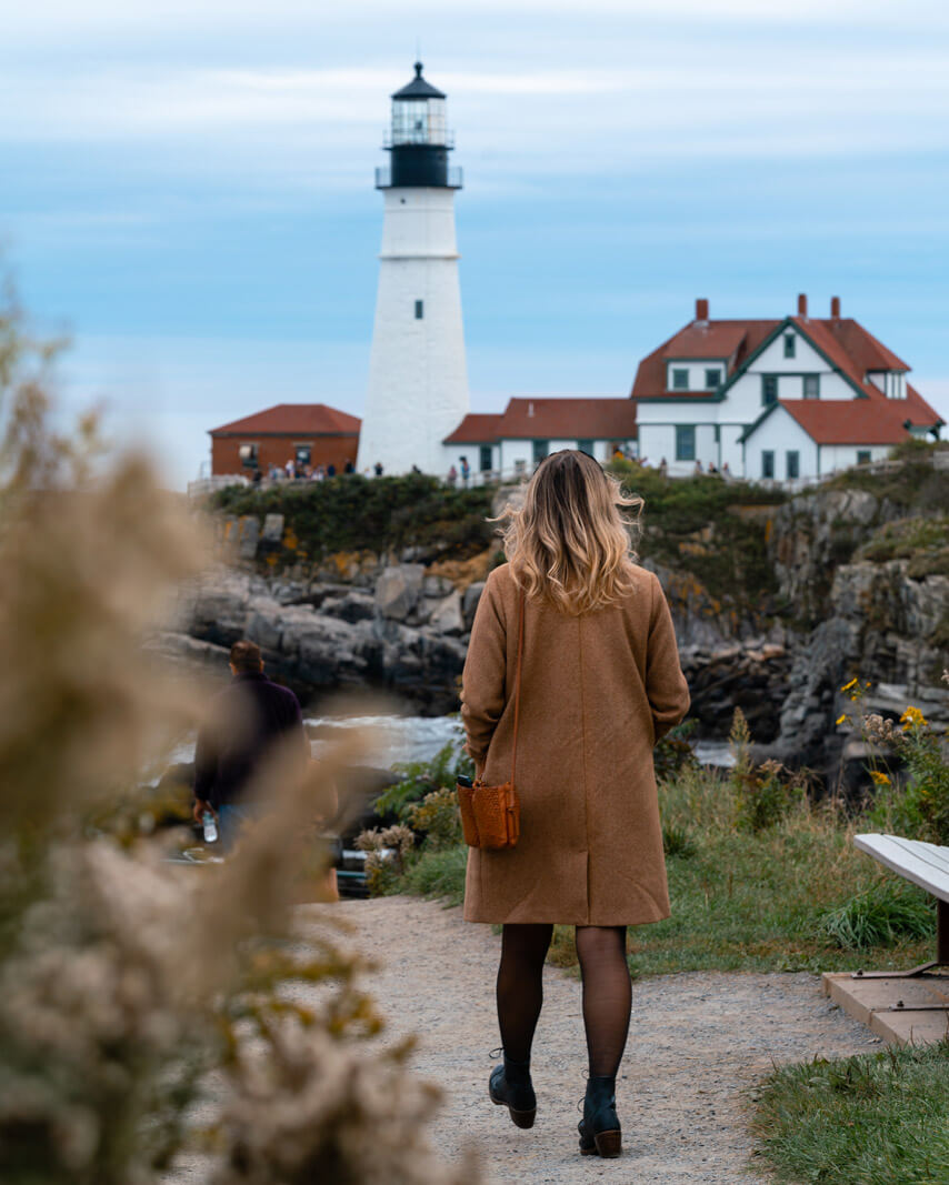 Megan walking on the lighthouse trail to Portland Head Light in Portland Maine