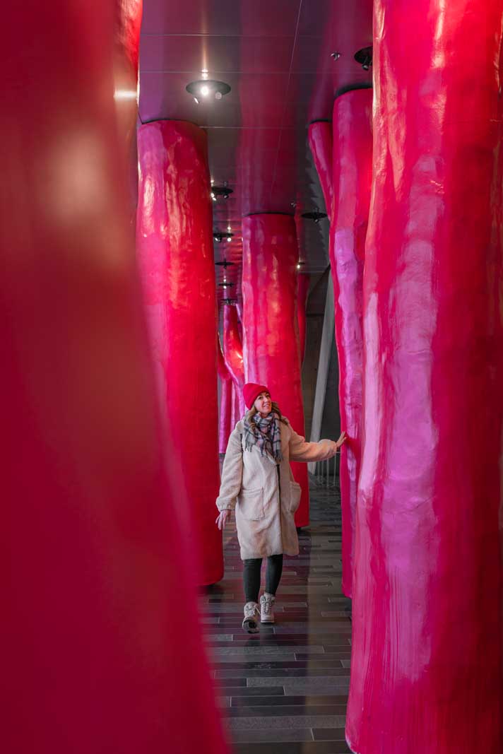 Megan walking through Lipstick Forest by Claude Cormier in Palais Congres in Montreal