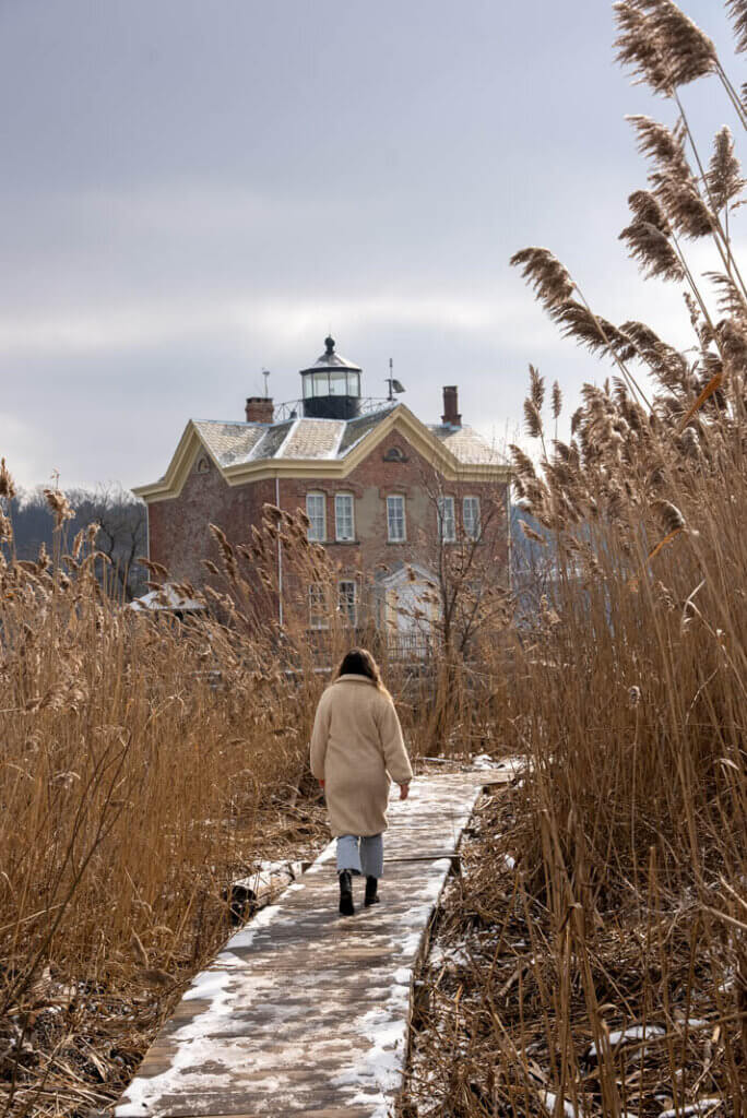 Megan walking toward Saugerties Lighthouse on the trail along the Hudson River in Saugerties NY