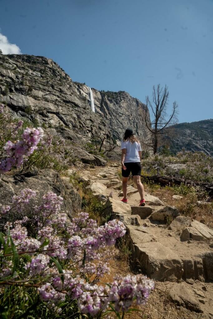 Megan walking towards Tueeulala Falls at Hetch Hetchy Valley in Yosemite National Park in California