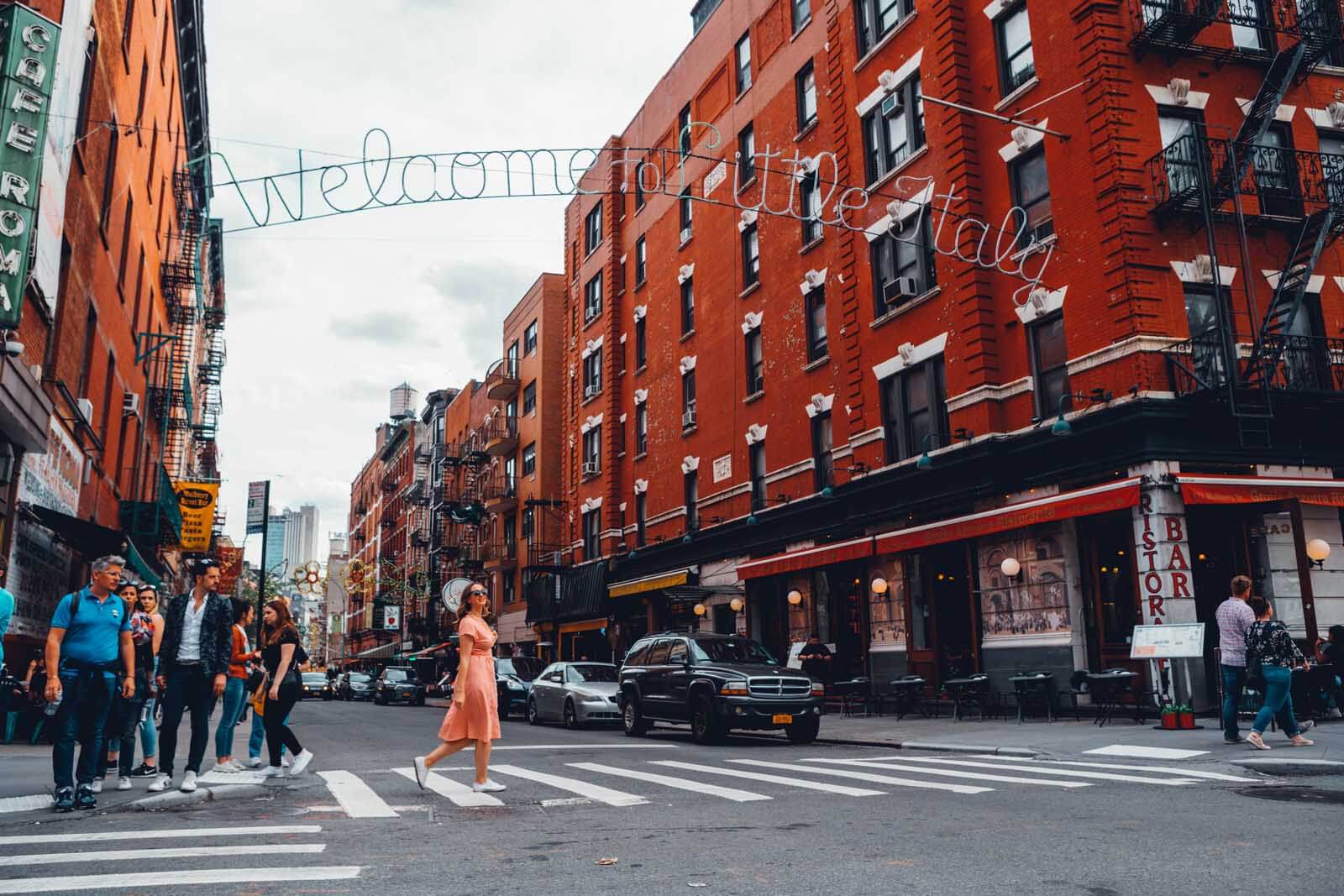 Megan walking under the Little Italy Sign in New York City